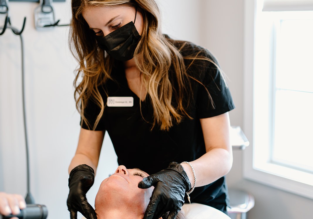 Aesthetic provider caring for a patient during a facial treatment